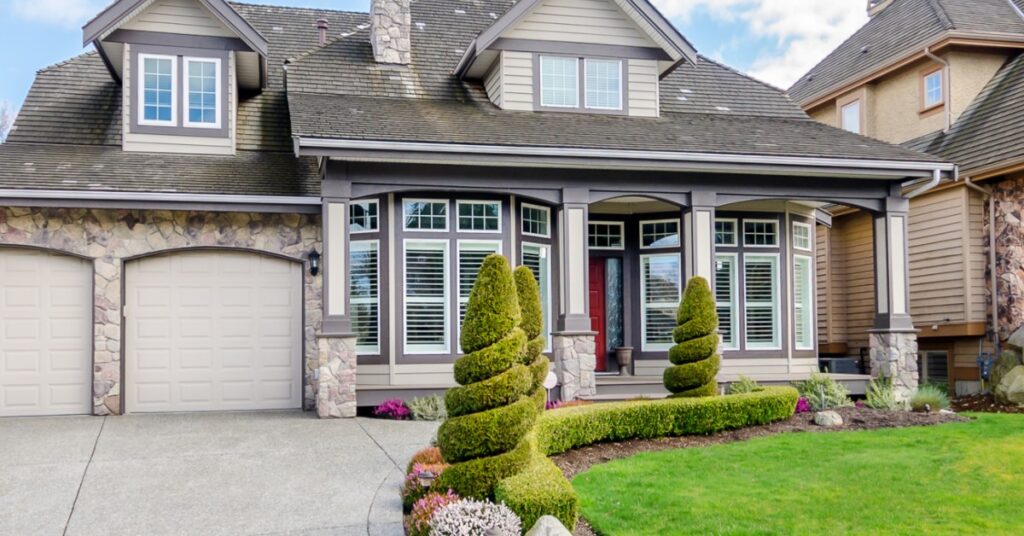 beautiful landscaping in front lawn of home