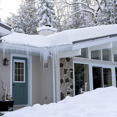 snowy house with icicles