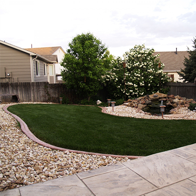 backyard landscaping with home in background