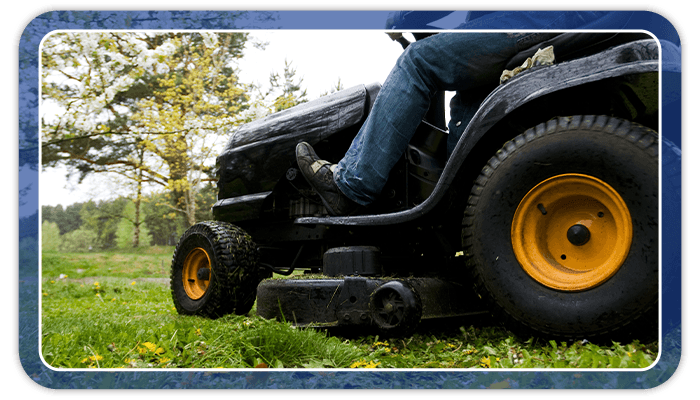 Image of someone mowing their lawn during the Fall
