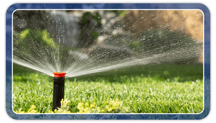 Image of a sprinkler watering a lawn