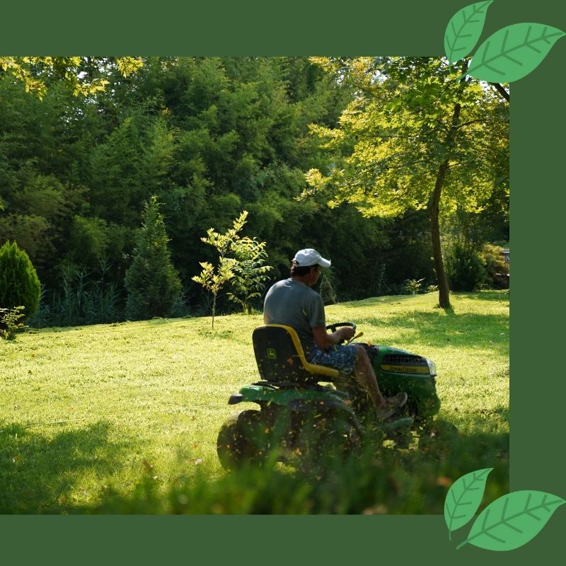 man sitting on riding lawn mower